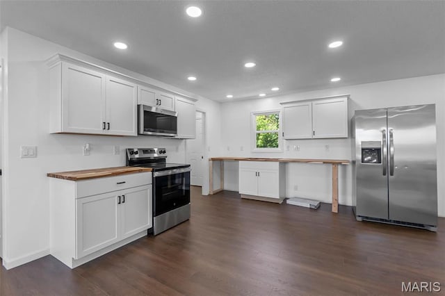 2047 State Highway H, Sikeston, MO 63801 - kitchen with appliances with stainless steel finishes, butcher block countertops, dark wood-style flooring, white cabinetry, and recessed lighting