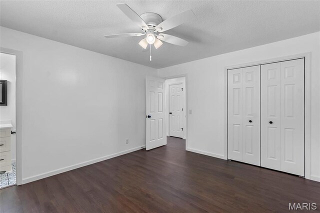 2047 State Highway H, Sikeston, MO 63801 - unfurnished bedroom featuring dark wood-style floors, baseboards, a textured ceiling, a closet, and ensuite bathroom