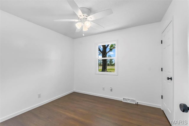 2047 State Highway H, Sikeston, MO 63801 - empty room featuring a ceiling fan, dark wood-style floors, and baseboards