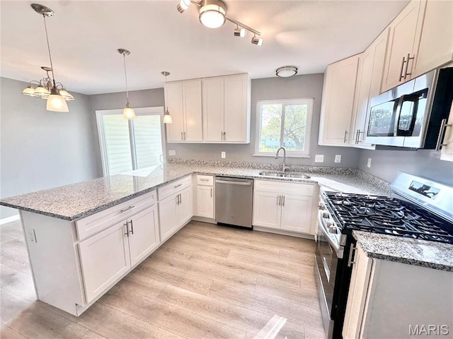 2944 Advance Dr, Florissant, MO 63031 - kitchen with stainless steel appliances, a peninsula, a sink, and white cabinets