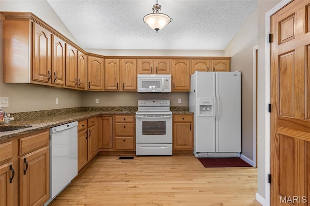 511 Log Cabin Rd, Farmington, MO 63640 - kitchen with white appliances, light wood-type flooring, vaulted ceiling, a textured ceiling, and brown cabinetry