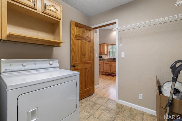 511 Log Cabin Rd, Farmington, MO 63640 - laundry area with washer / dryer, cabinet space, baseboards, a textured ceiling, and light tile patterned flooring