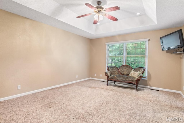511 Log Cabin Rd, Farmington, MO 63640 - living area with a raised ceiling, a ceiling fan, carpet flooring, baseboards, and a textured ceiling