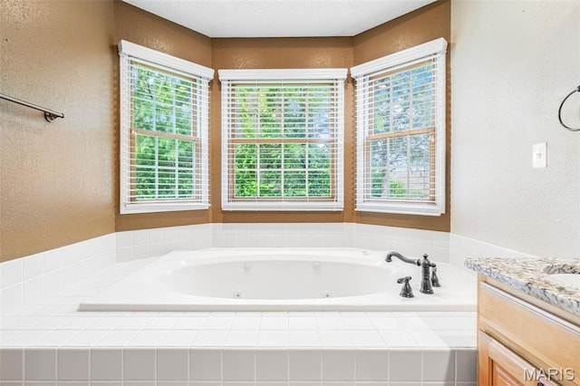 511 Log Cabin Rd, Farmington, MO 63640 - full bathroom featuring a textured wall, healthy amount of natural light, a whirlpool tub, and vanity