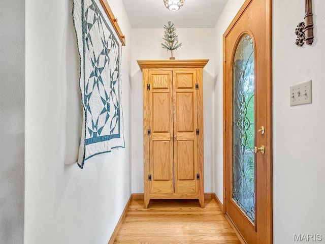entryway featuring light wood-style floors and baseboards