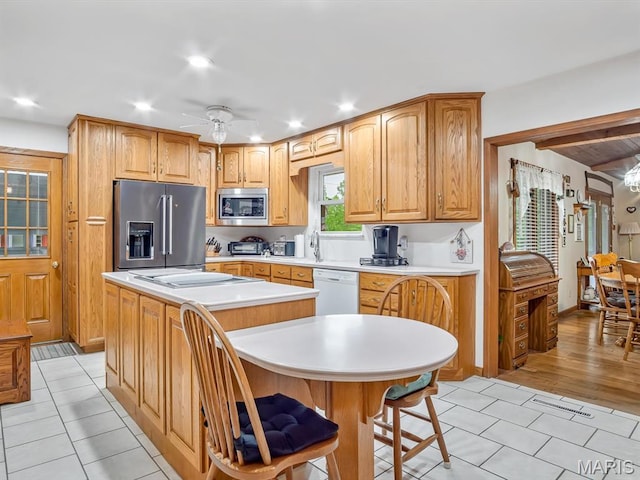 kitchen with stainless steel appliances, light countertops, a ceiling fan, light tile patterned floors, and recessed lighting