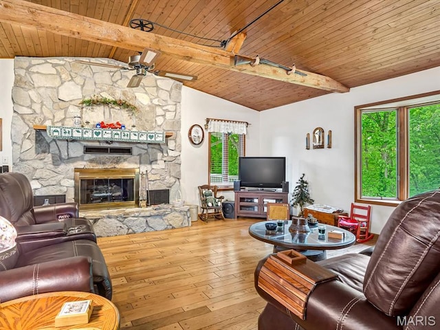 living area featuring wood ceiling, a fireplace, hardwood / wood-style floors, and ceiling fan