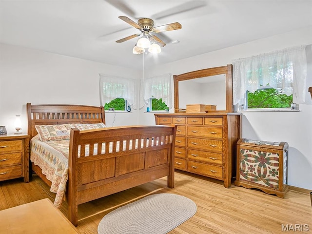 bedroom with light wood-style floors and ceiling fan