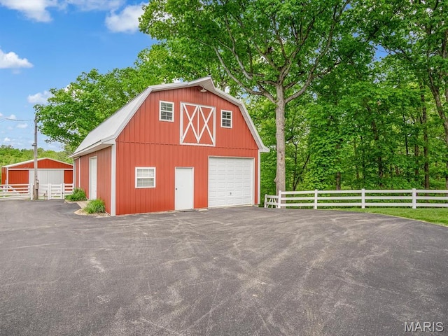 detached garage with fence and driveway