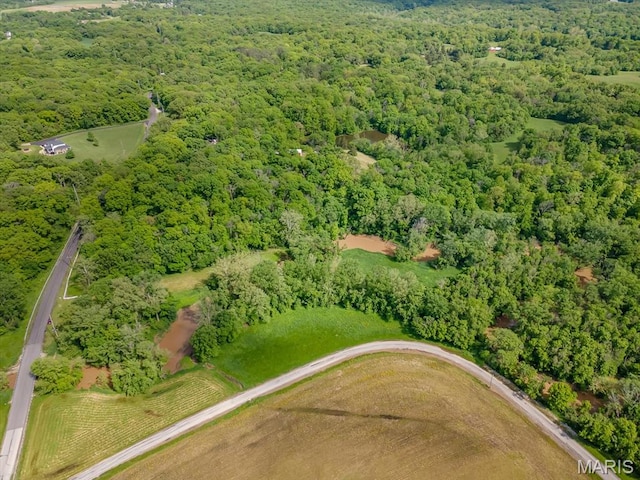 aerial view of property's location with a heavily wooded area