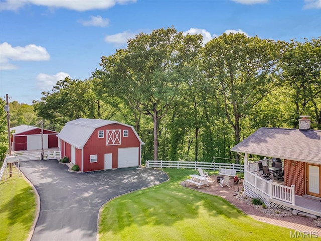 view of barn with view of wooded area