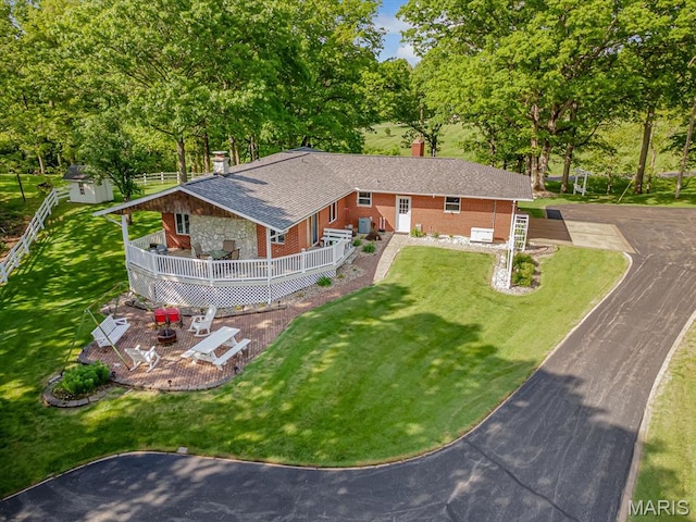 aerial view of property and surrounding area featuring a tree filled landscape