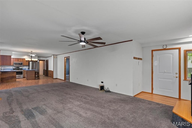 418 E Maple St, Gillespie, IL 62033 - unfurnished living room with ceiling fan, light carpet, and a chandelier