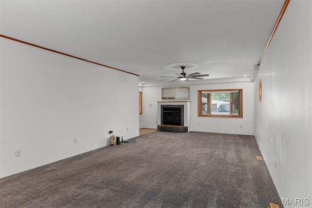 418 E Maple St, Gillespie, IL 62033 - unfurnished living room with ceiling fan, carpet flooring, and a fireplace with raised hearth