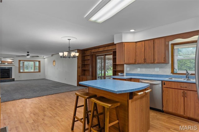 418 E Maple St, Gillespie, IL 62033 - kitchen featuring stainless steel dishwasher, a sink, ceiling fan, light wood-style floors, and a chandelier