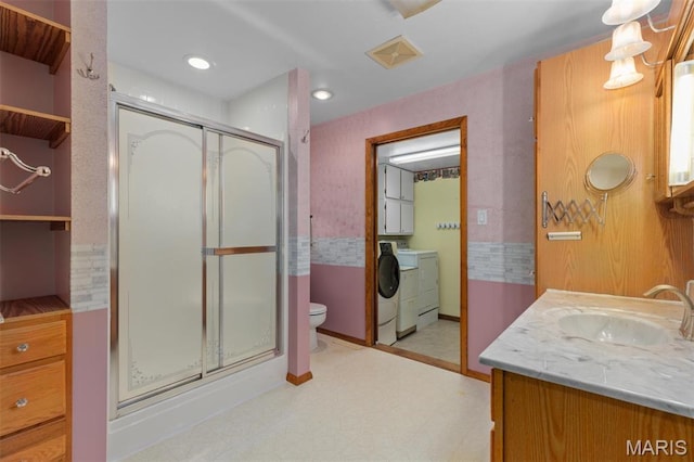 418 E Maple St, Gillespie, IL 62033 - full bath with washer and clothes dryer, a stall shower, tile patterned floors, vanity, and toilet