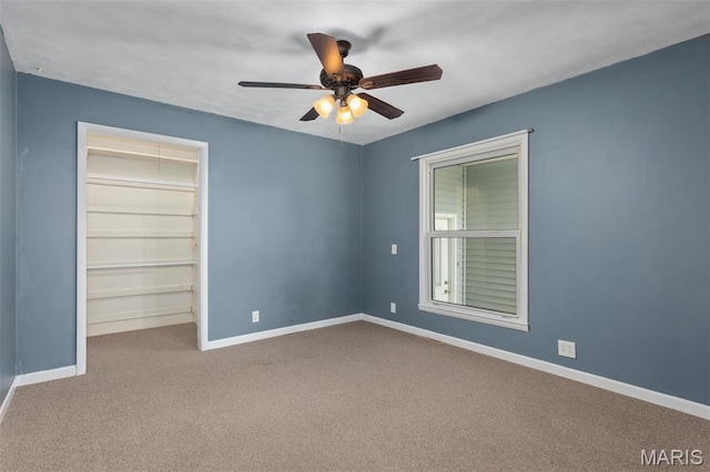 418 E Maple St, Gillespie, IL 62033 - unfurnished bedroom with carpet, baseboards, a walk in closet, ceiling fan, and a closet