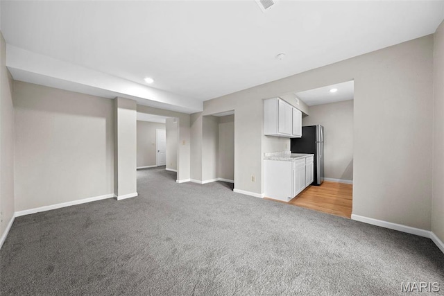 2104 Gascony Dr Unit 2104, Lake St Louis, MO 63367 - unfurnished living room with light carpet, baseboards, and recessed lighting