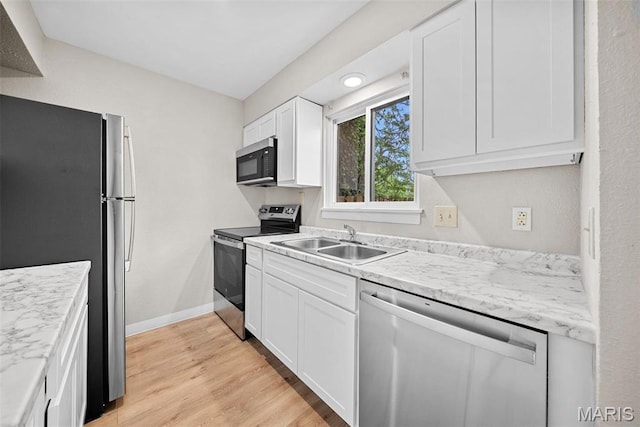 2104 Gascony Dr Unit 2104, Lake St Louis, MO 63367 - kitchen with stainless steel appliances, a sink, light wood finished floors, white cabinetry, and light countertops