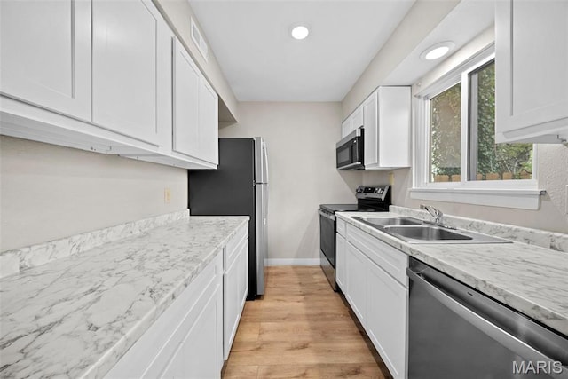 2104 Gascony Dr Unit 2104, Lake St Louis, MO 63367 - kitchen featuring appliances with stainless steel finishes, a sink, white cabinets, light wood finished floors, and light countertops
