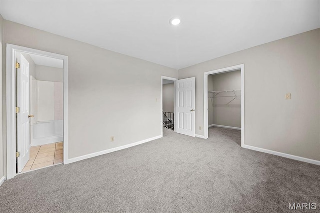 2104 Gascony Dr Unit 2104, Lake St Louis, MO 63367 - unfurnished bedroom with carpet, baseboards, a spacious closet, a closet, and connected bathroom