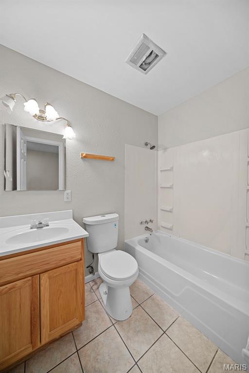 2104 Gascony Dr Unit 2104, Lake St Louis, MO 63367 - bathroom featuring  shower combination, vanity, toilet, tile patterned flooring, and a chandelier