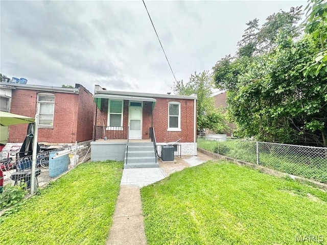 2806 Keokuk St, Saint Louis, MO 63118 - view of front facade with central AC unit, brick siding, and a porch