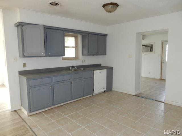 201 Quapaw, Steele, MO 63877 - kitchen with dishwasher, dark countertops, gray cabinetry, a wall mounted AC, and a sink