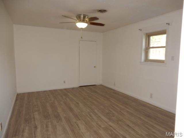 201 Quapaw, Steele, MO 63877 - spare room with a ceiling fan, wood finished floors, and baseboards