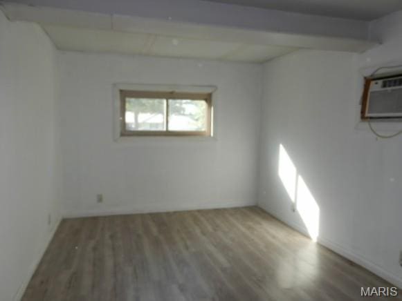201 Quapaw, Steele, MO 63877 - empty room with wood finished floors and a wall mounted AC