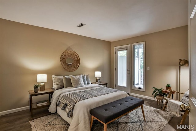 bedroom with baseboards, dark wood-type flooring, and access to outside