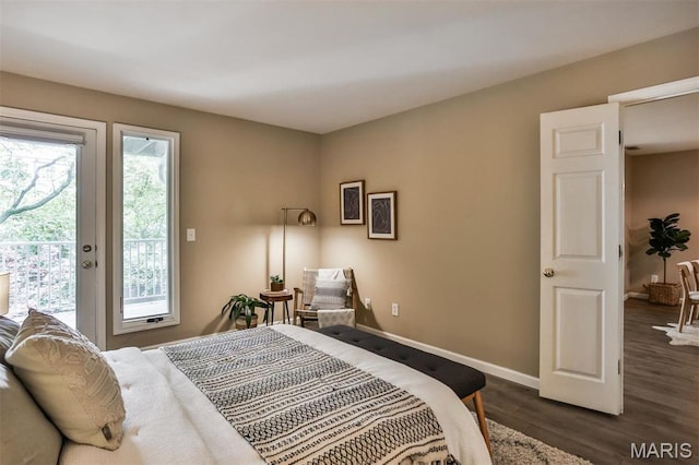 bedroom featuring access to exterior, baseboards, and dark wood finished floors