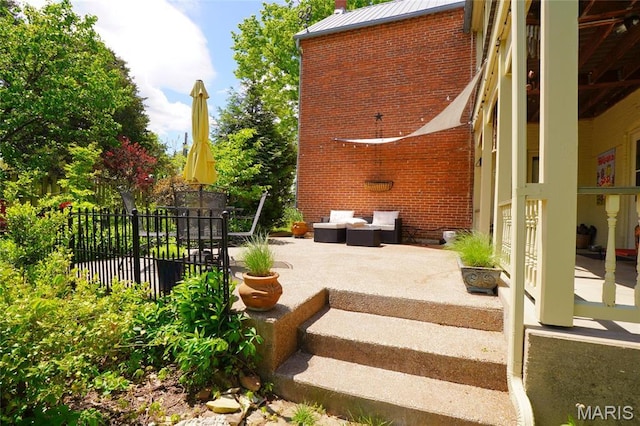 view of patio with an outdoor hangout area and fence