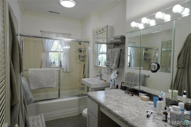 bathroom with crown molding, bath / shower combo with glass door, and vanity