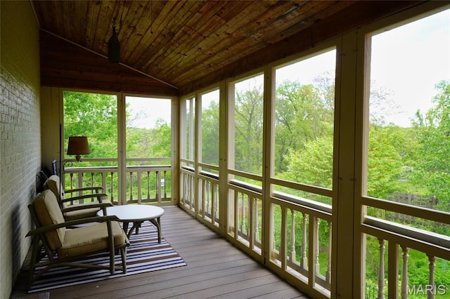 sunroom / solarium featuring lofted ceiling