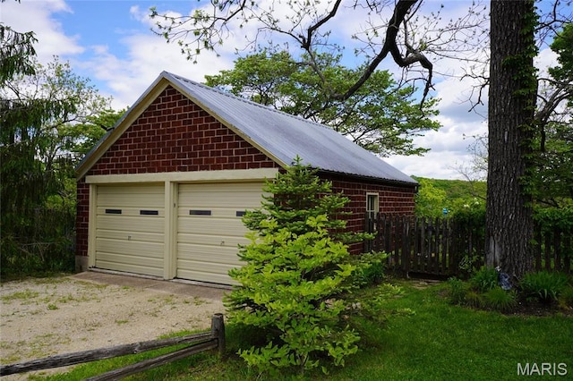 detached garage featuring fence