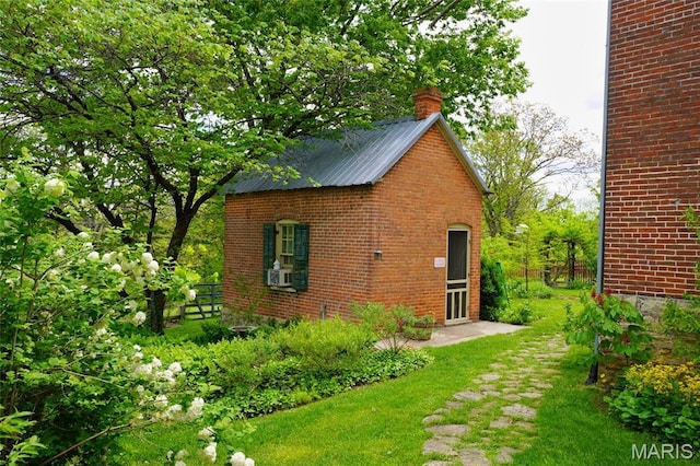 view of outbuilding featuring cooling unit and fence