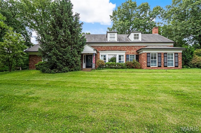 7 Robin Hill Ln, Ladue, MO 63124 - view of front of house with brick siding, a chimney, and a front yard