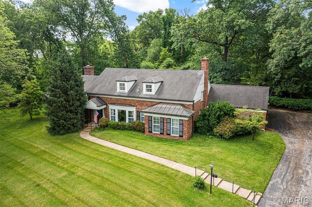 7 Robin Hill Ln, Ladue, MO 63124 - view of front of house featuring a chimney, brick siding, and a front yard
