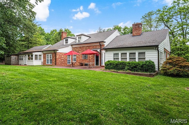 7 Robin Hill Ln, Ladue, MO 63124 - rear view of house with a chimney, a patio, a yard, and brick siding