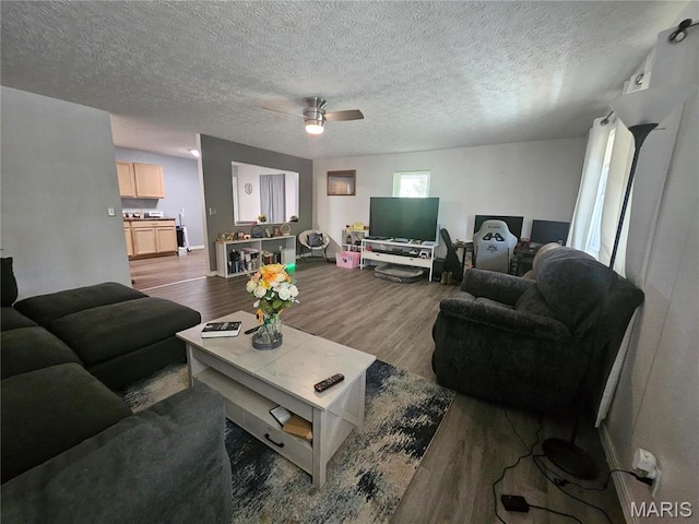 24355 Trolley Ln, Saint Robert, MO 65584 - living area with wood finished floors, ceiling fan, a textured ceiling, and baseboards