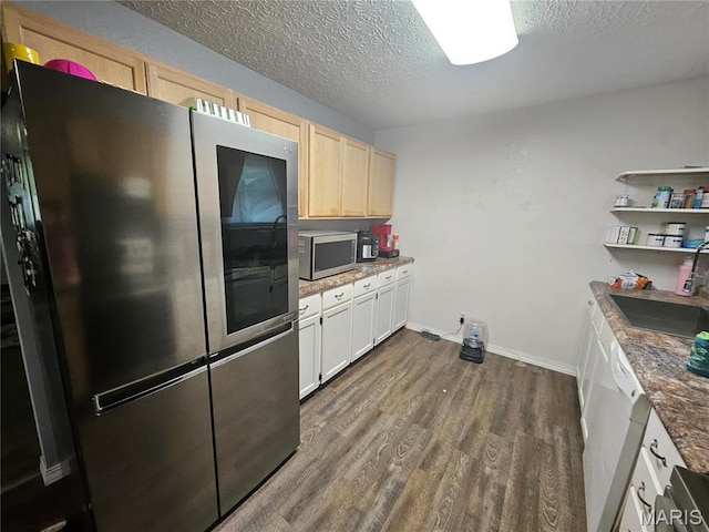 24355 Trolley Ln, Saint Robert, MO 65584 - kitchen with appliances with stainless steel finishes, a sink, dark wood-style floors, a textured ceiling, and baseboards