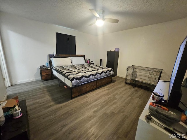 24355 Trolley Ln, Saint Robert, MO 65584 - bedroom with wood finished floors, baseboards, a textured ceiling, and ceiling fan