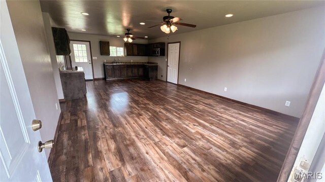 10268 Sunlight Rd, Belgrade, MO 63622 - unfurnished living room with dark wood-style floors, recessed lighting, a ceiling fan, a sink, and baseboards