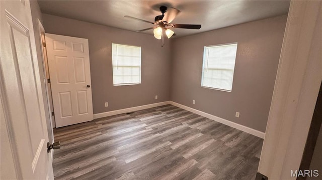 10268 Sunlight Rd, Belgrade, MO 63622 - unfurnished bedroom featuring dark wood finished floors, baseboards, and ceiling fan