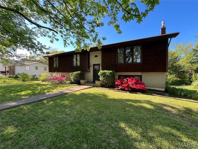 152 Burchwood Dr, St James, MO 65559 - split foyer home featuring a front yard, a chimney, and brick siding
