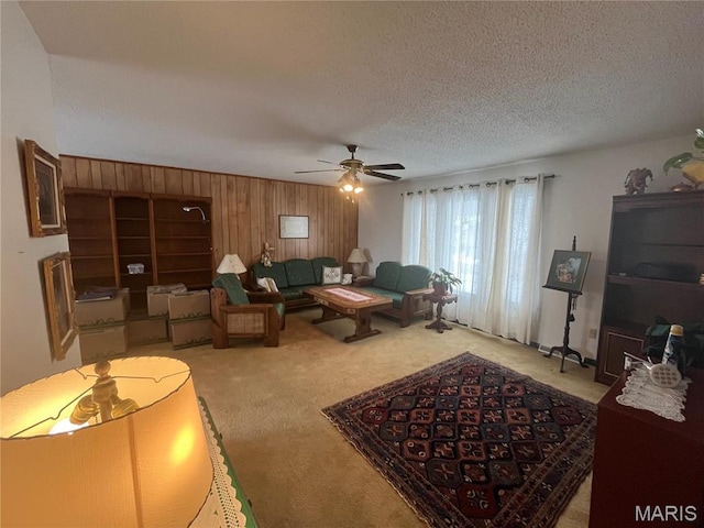 152 Burchwood Dr, St James, MO 65559 - living room with light colored carpet, a textured ceiling, a ceiling fan, and wooden walls