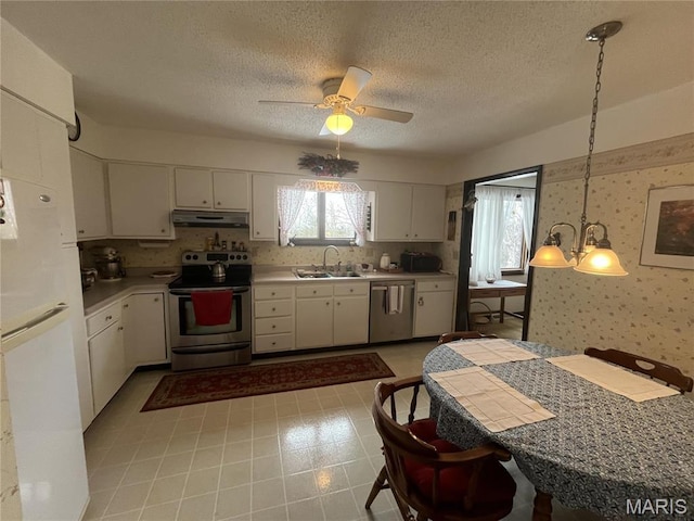 152 Burchwood Dr, St James, MO 65559 - kitchen featuring stainless steel appliances, under cabinet range hood, light countertops, white cabinetry, and a ceiling fan