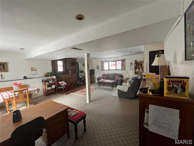 152 Burchwood Dr, St James, MO 65559 - living area featuring carpet floors, healthy amount of natural light, a wood stove, and wooden walls