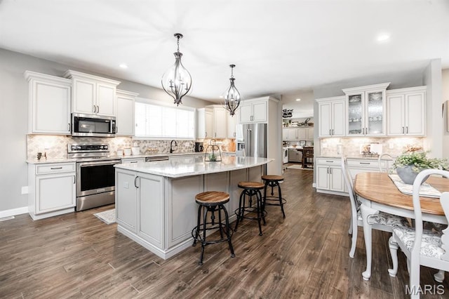 9 Shellie Ct, Fairview Heights, IL 62208 - kitchen with stainless steel appliances, a kitchen island, tasteful backsplash, recessed lighting, and white cabinets